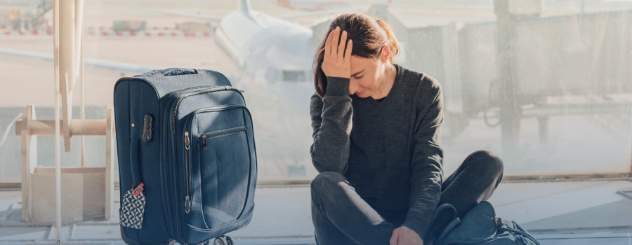 A passenger with a hand-luggage looking unhappy