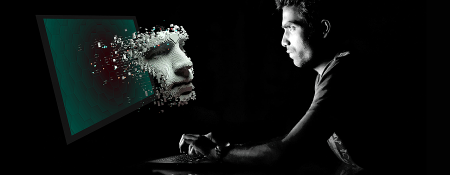 Artificial intelligence: man looking at a screen in the dark